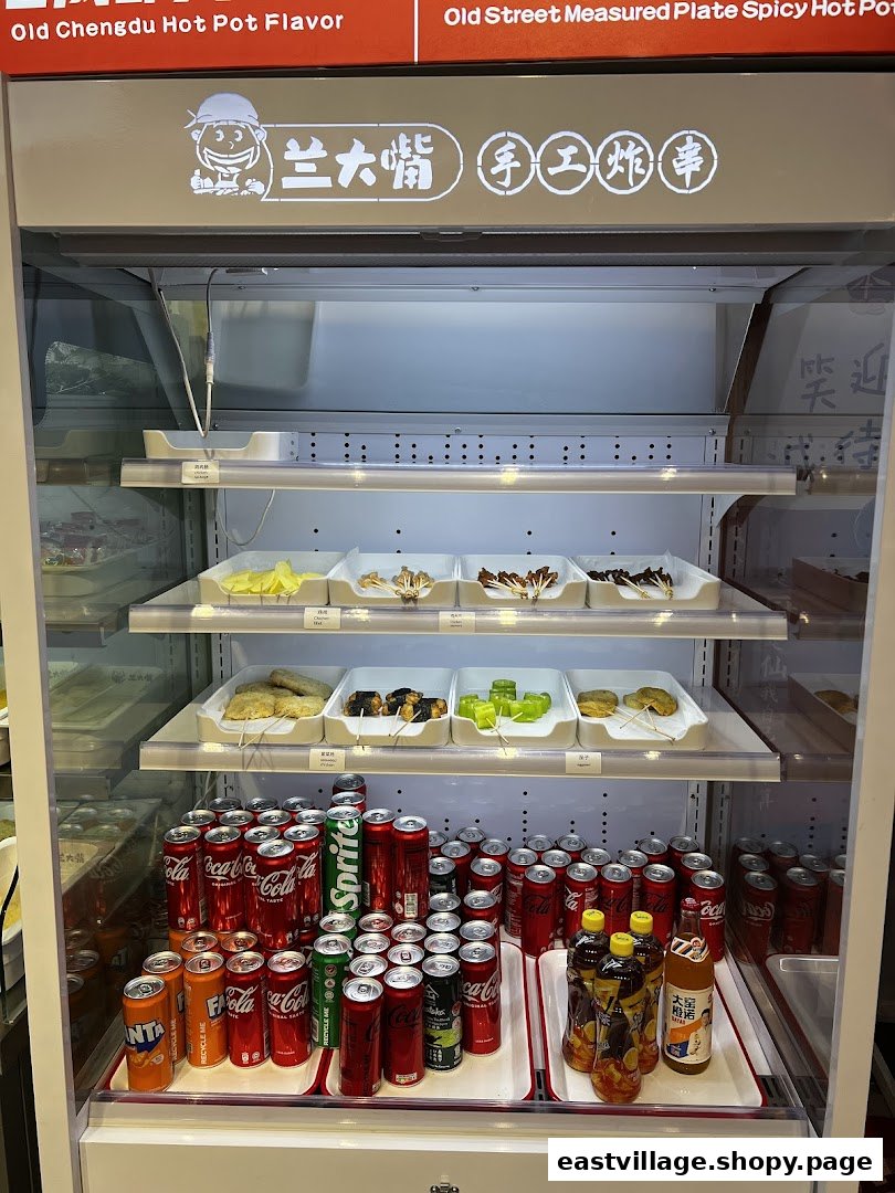 A display fridge inside Lan Da Zui featuring fresh hot pot ingredients and a variety of cold beverages.