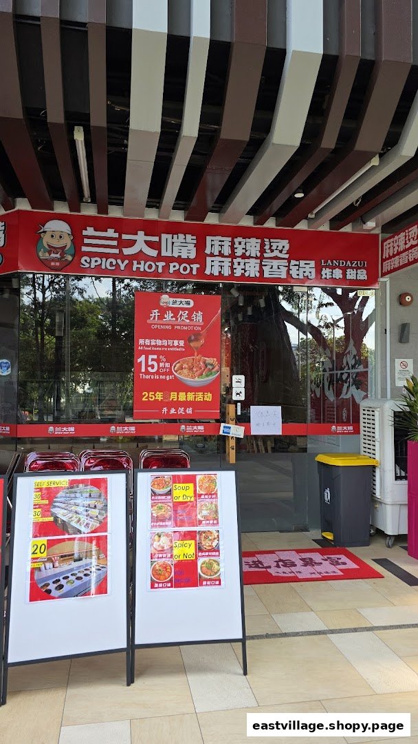 The vibrant red storefront of Lan Da Zui Spicy Hot Pot, featuring promotional signs and self-service displays.
