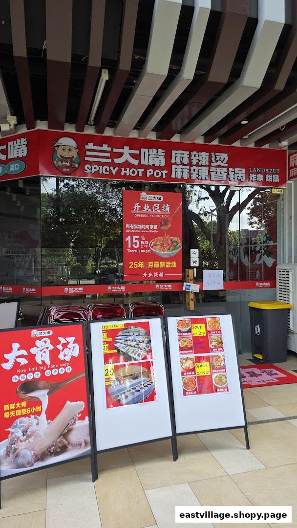 The vibrant red storefront of Lan Da Zui, a spicy hot pot restaurant, with promotional signs.