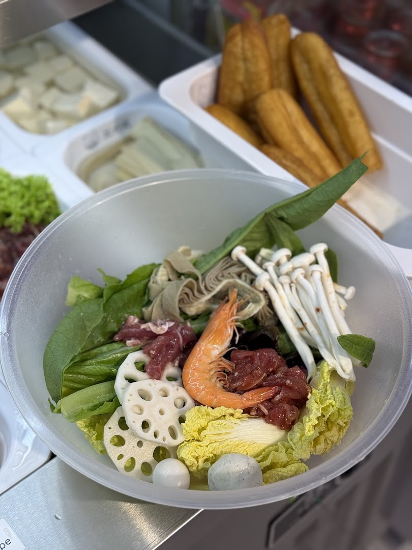A vibrant bowl of fresh ingredients for a customizable hot pot or malatang meal.