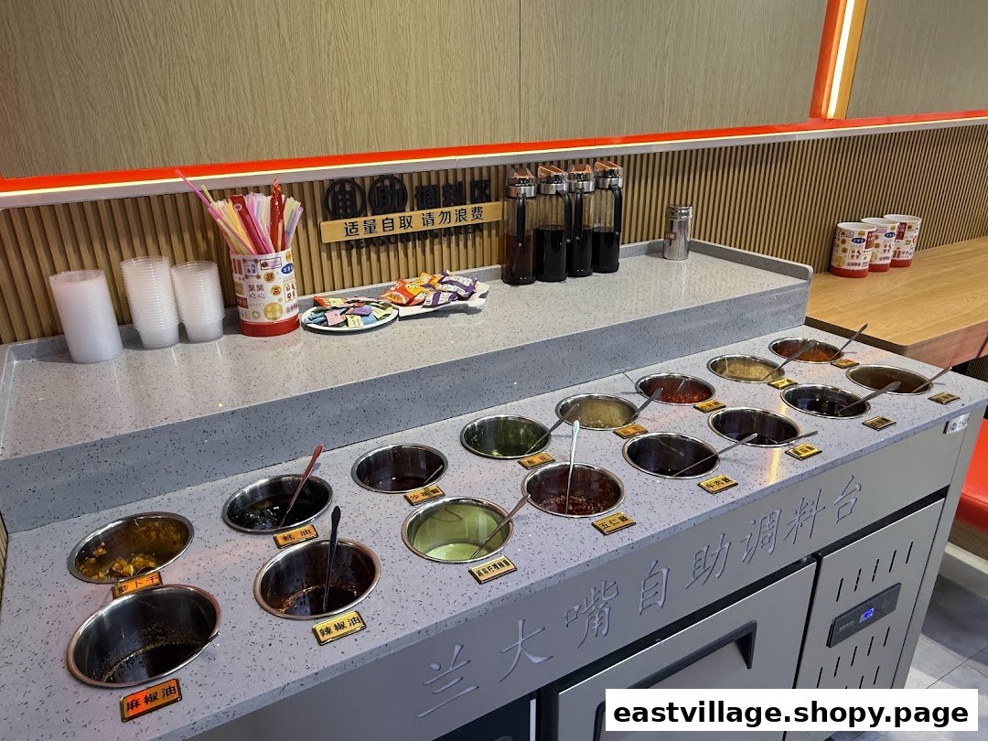 A self-service condiment bar at Lan Da Zui, offering various sauces and toppings.