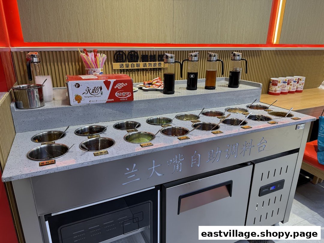 A self-service condiment bar at Lan Da Zui, featuring various sauces and toppings for customers.