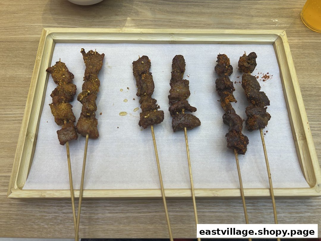 Six delicious skewers of seasoned meat served on a bamboo tray.