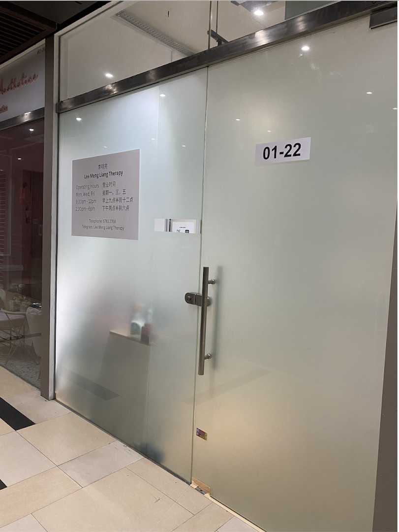 A frosted glass shop front for Lee Meng Liang Therapy, displaying operating hours and contact information.