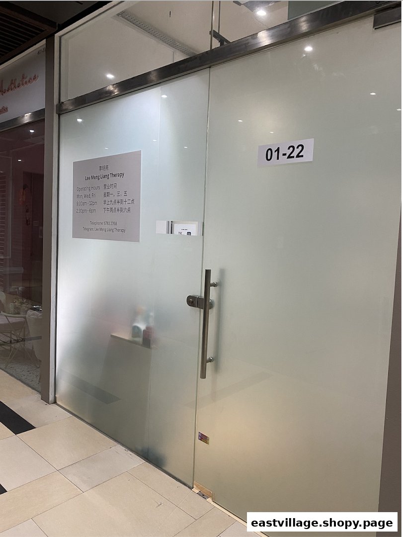 A frosted glass shop front for Lee Meng Liang Therapy, displaying operating hours and contact information.