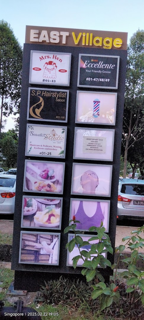 A directory board for East Village showcasing various shops and services, including a therapy center.
