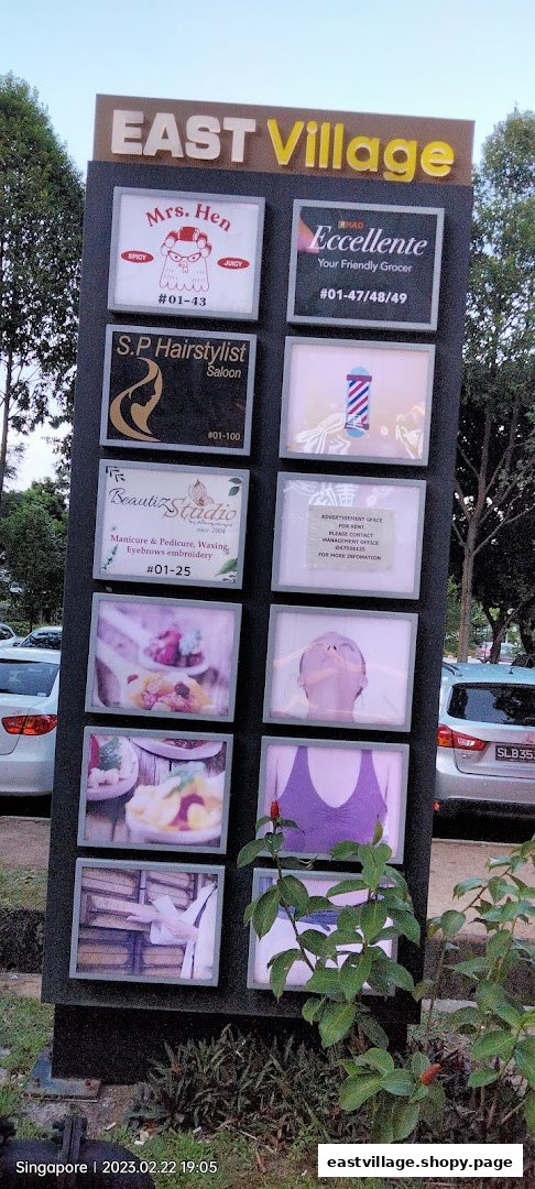A directory board for East Village showcasing various shops and services, including a therapy center.
