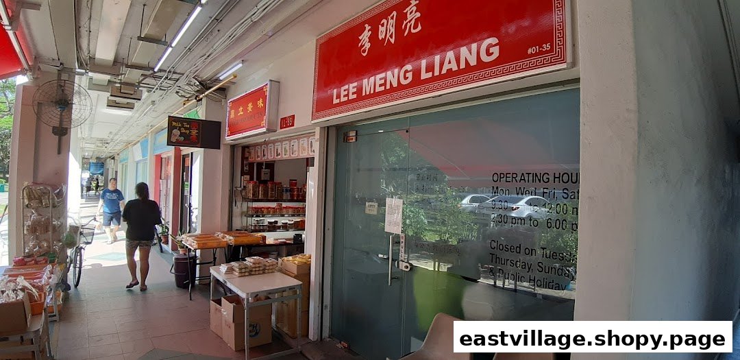 The exterior of Lee Meng Liang shop with its red signage, glass entrance, and operating hours displayed.