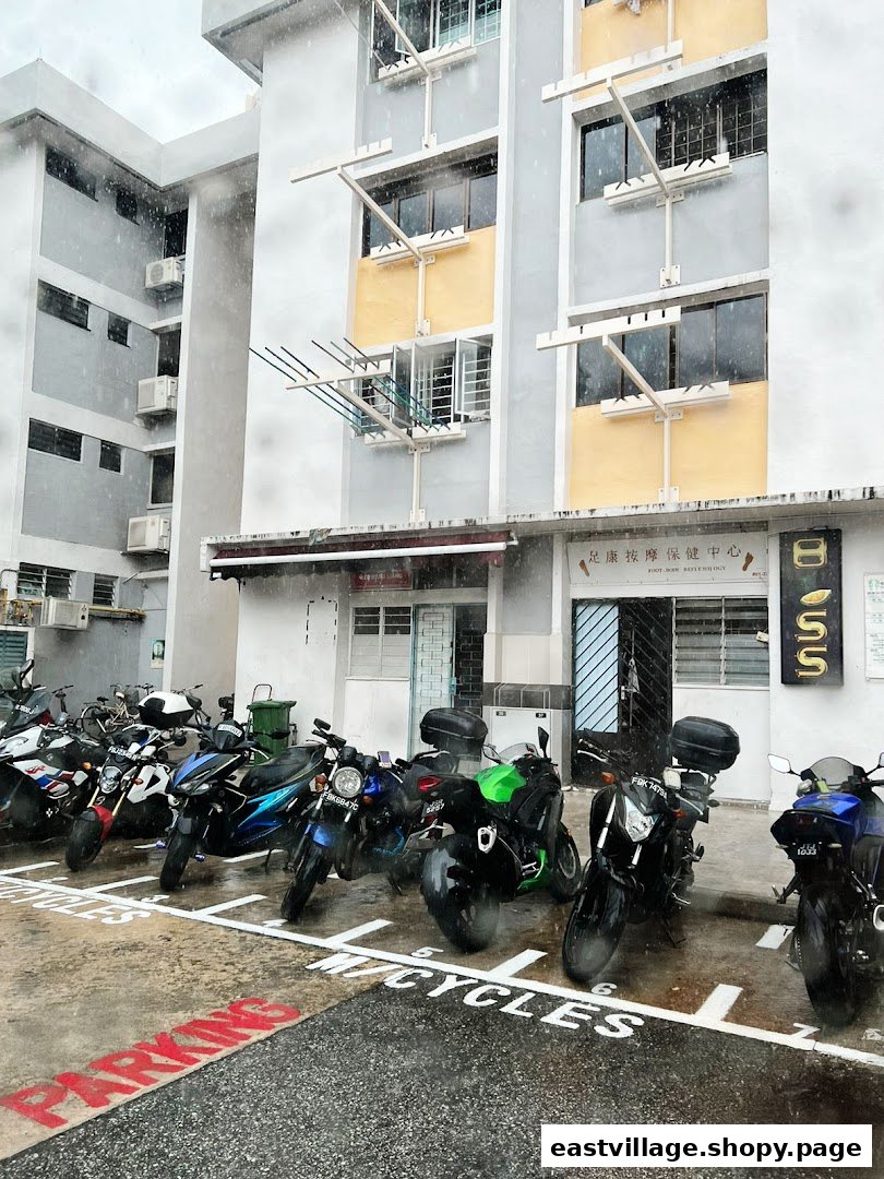 The exterior of Lee Meng Liang Therapy, showing its entrance, building facade, and parked motorcycles.