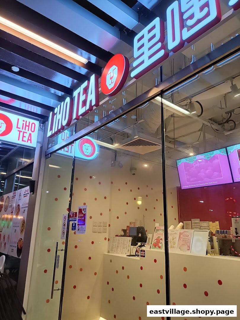 The brightly lit exterior of LiHO TEA at East Village, showcasing its prominent signage and inviting entrance.