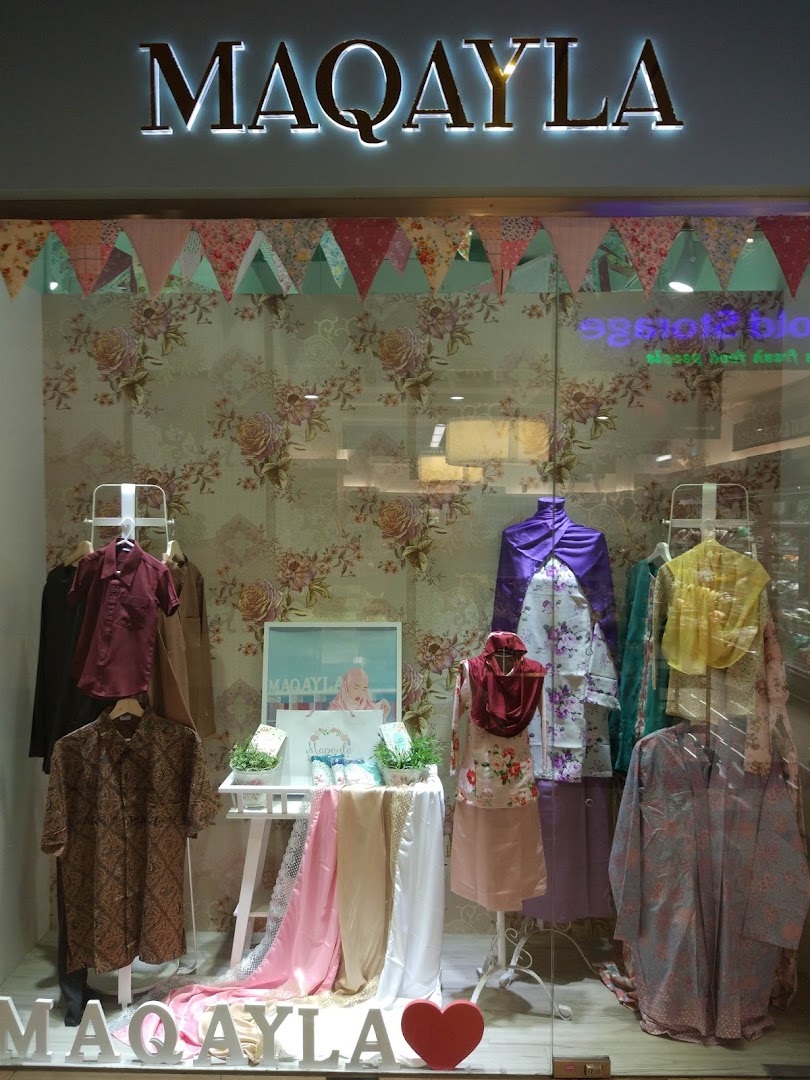 The storefront of MAQAYLA, showcasing a vibrant display of modest fashion and traditional apparel.