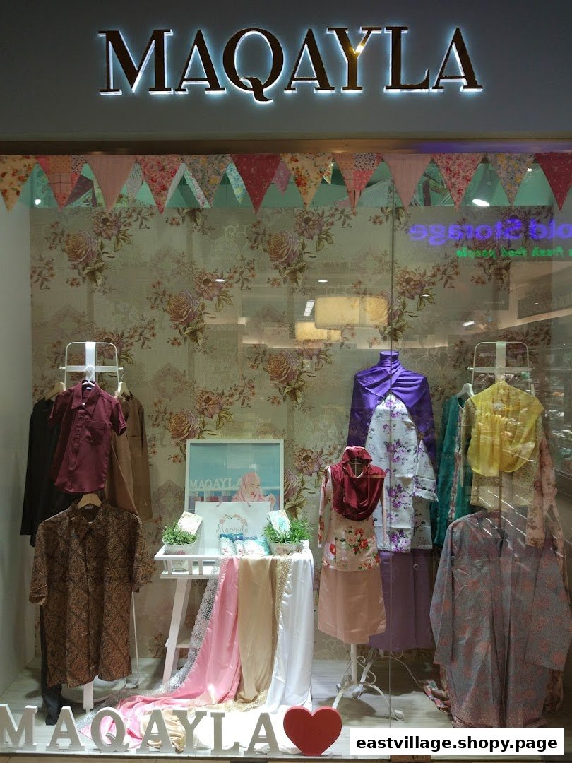 The storefront of MAQAYLA, showcasing a vibrant display of modest fashion and traditional apparel.