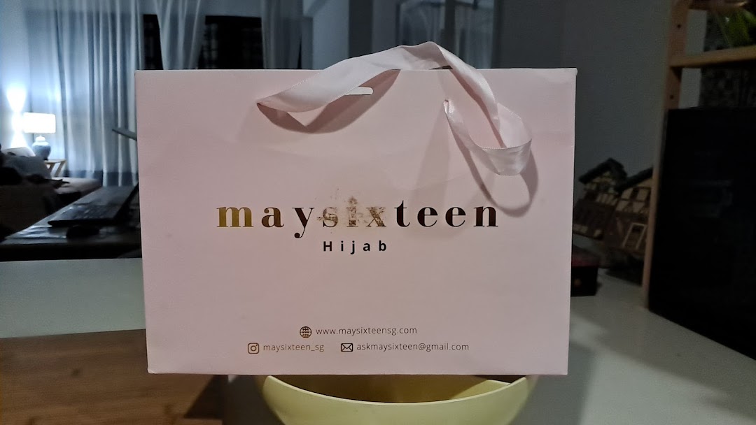 A pink Maysixteen shopping bag featuring the brand's logo and 'Hijab' tagline.