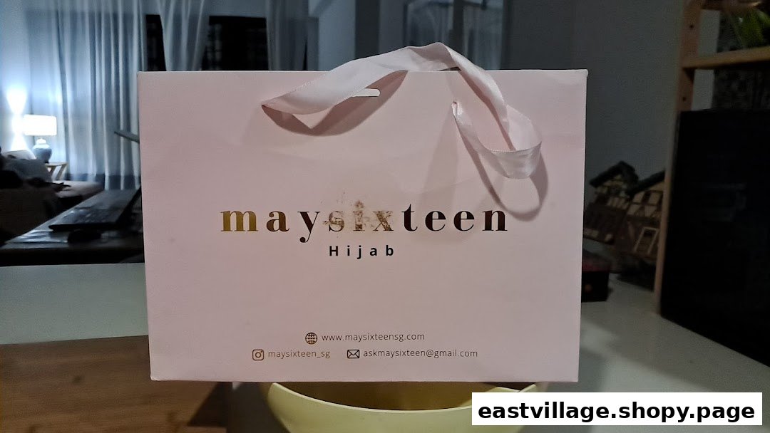 A pink Maysixteen shopping bag featuring the brand's logo and 'Hijab' tagline.