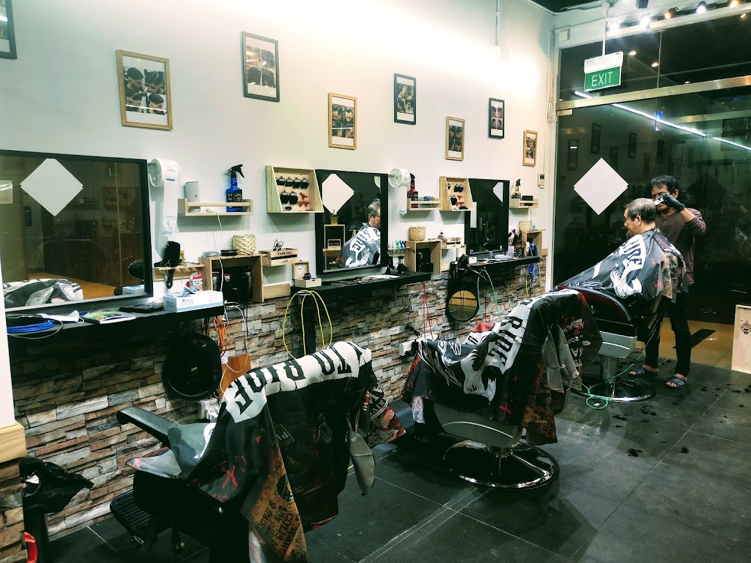 A barber attends to a client in a modern, well-lit barber shop with multiple stations.
