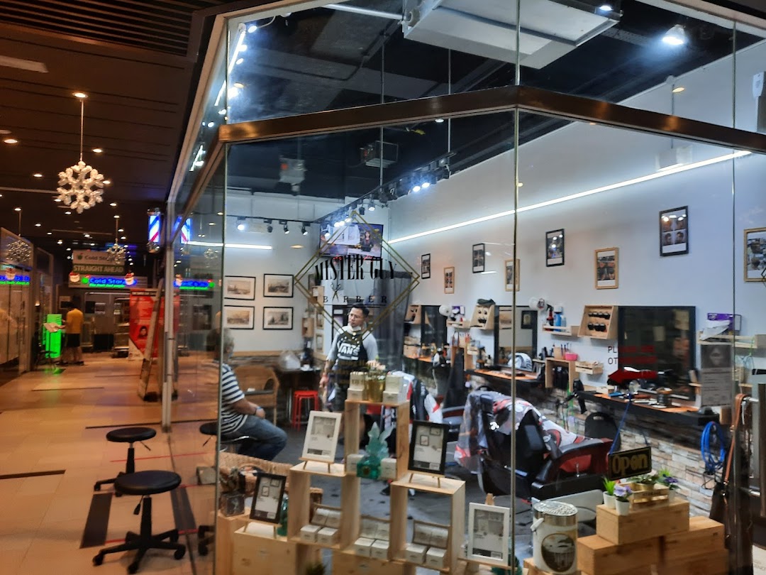 Exterior view of Mister Guy Barber, showcasing its modern interior and inviting shop front within a mall.