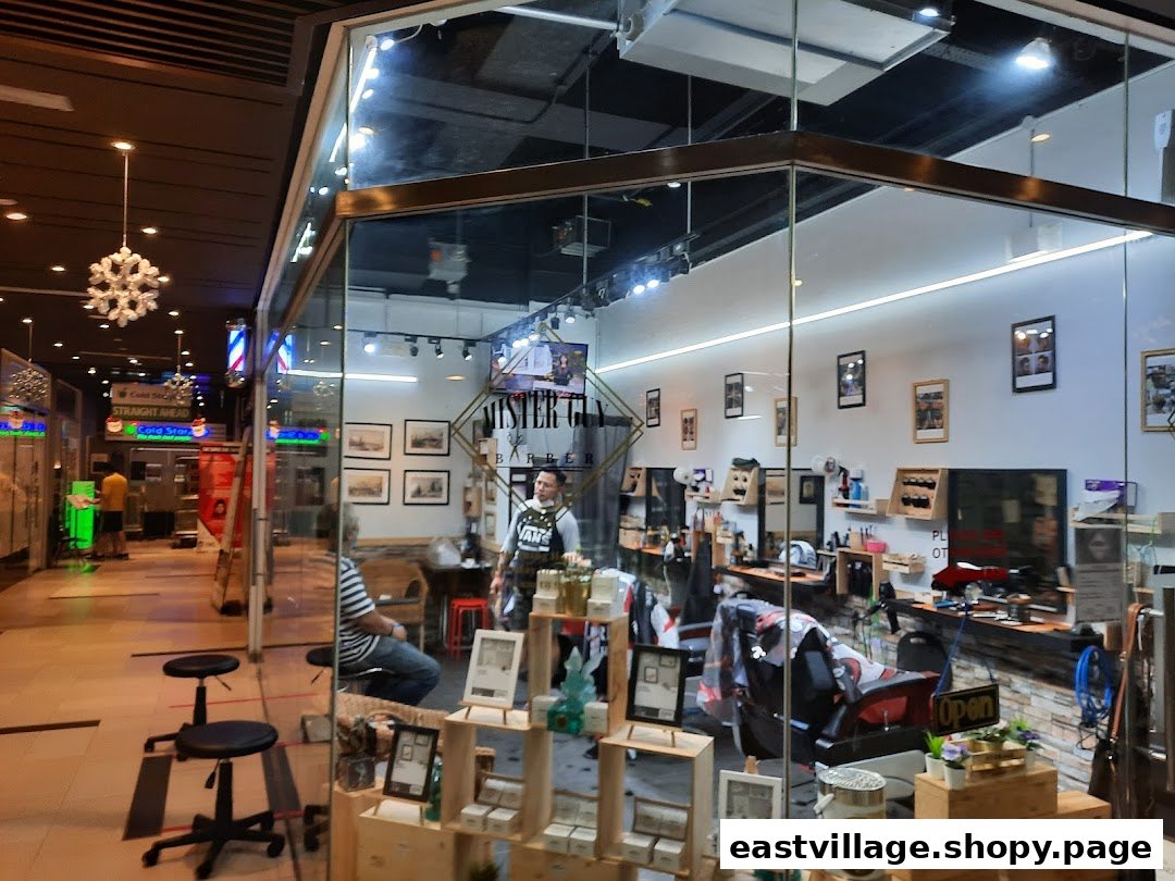 Exterior view of Mister Guy Barber, showcasing its modern interior and inviting shop front within a mall.