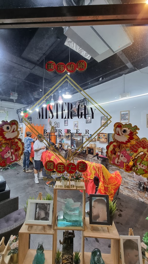 View into Mister Guy Barber shop, showing barbers at work and festive decorations.