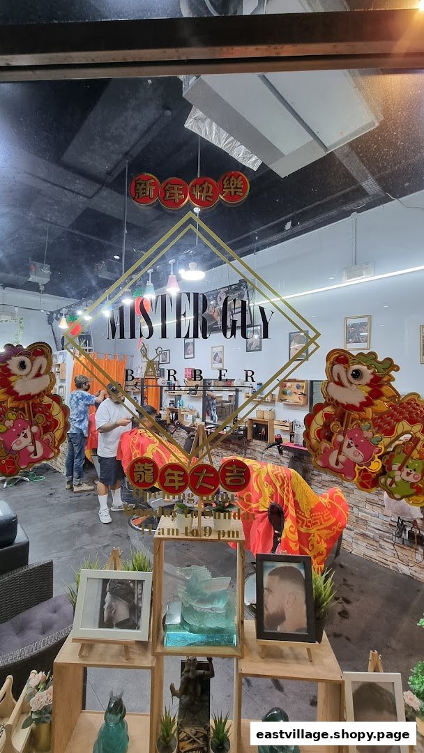 View into Mister Guy Barber shop, showing barbers at work and festive decorations.