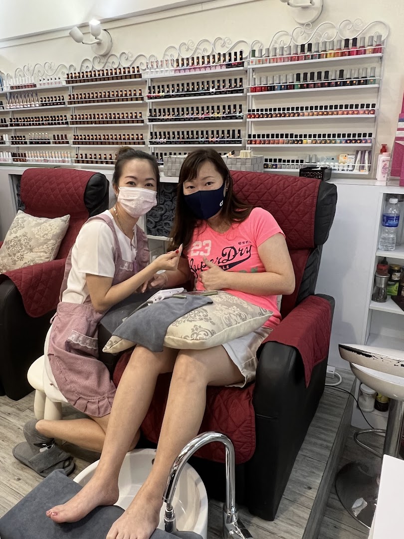 A nail technician provides manicure and pedicure services to a customer in a comfortable salon setting.