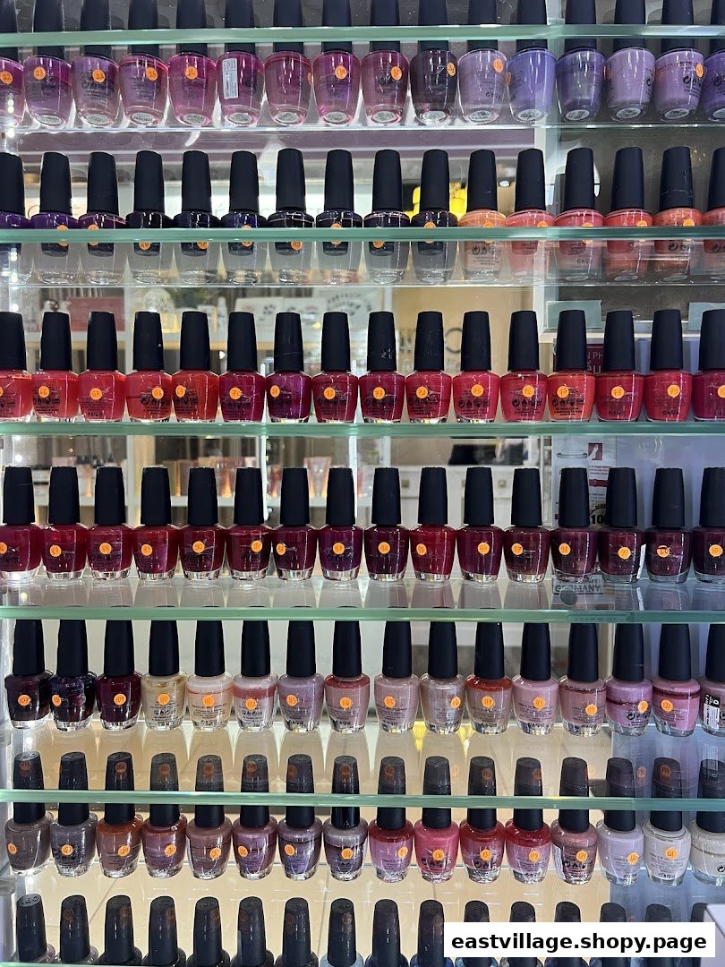 A vibrant display of numerous nail polish bottles in various colors on clear shelves.