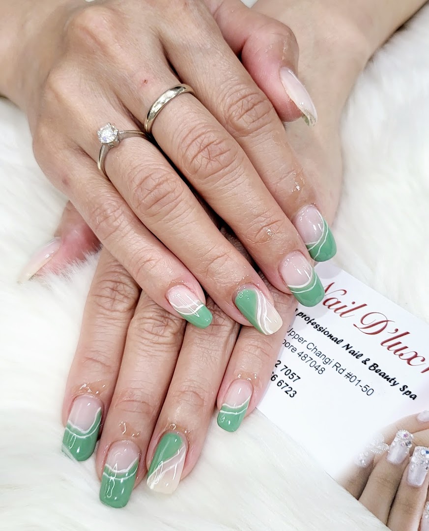 Close-up of hands showcasing a fresh manicure with green and white abstract nail art.
