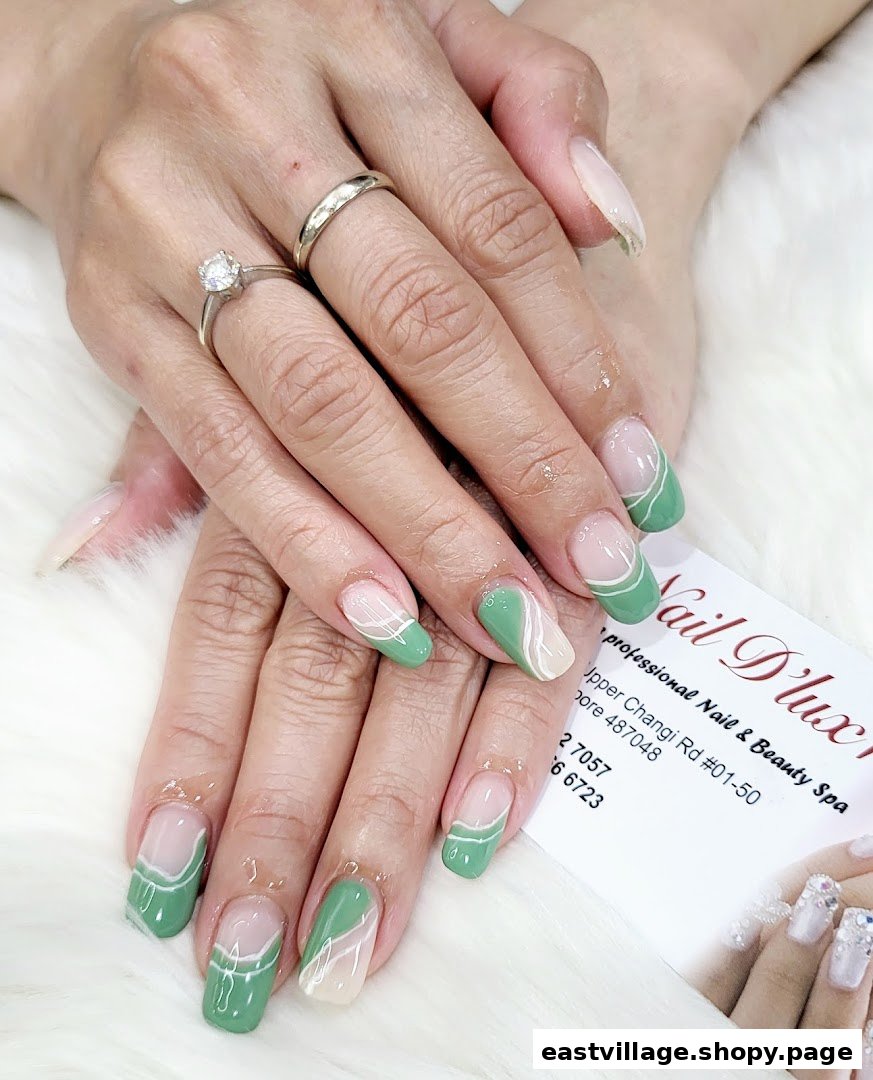Close-up of hands showcasing a fresh manicure with green and white abstract nail art.