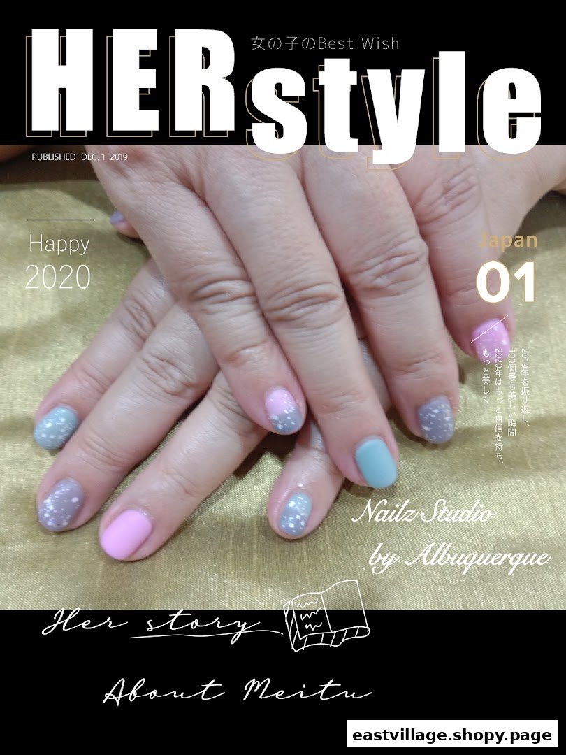 Close-up of hands showcasing a vibrant, glittery nail art design by Nailz Studio.