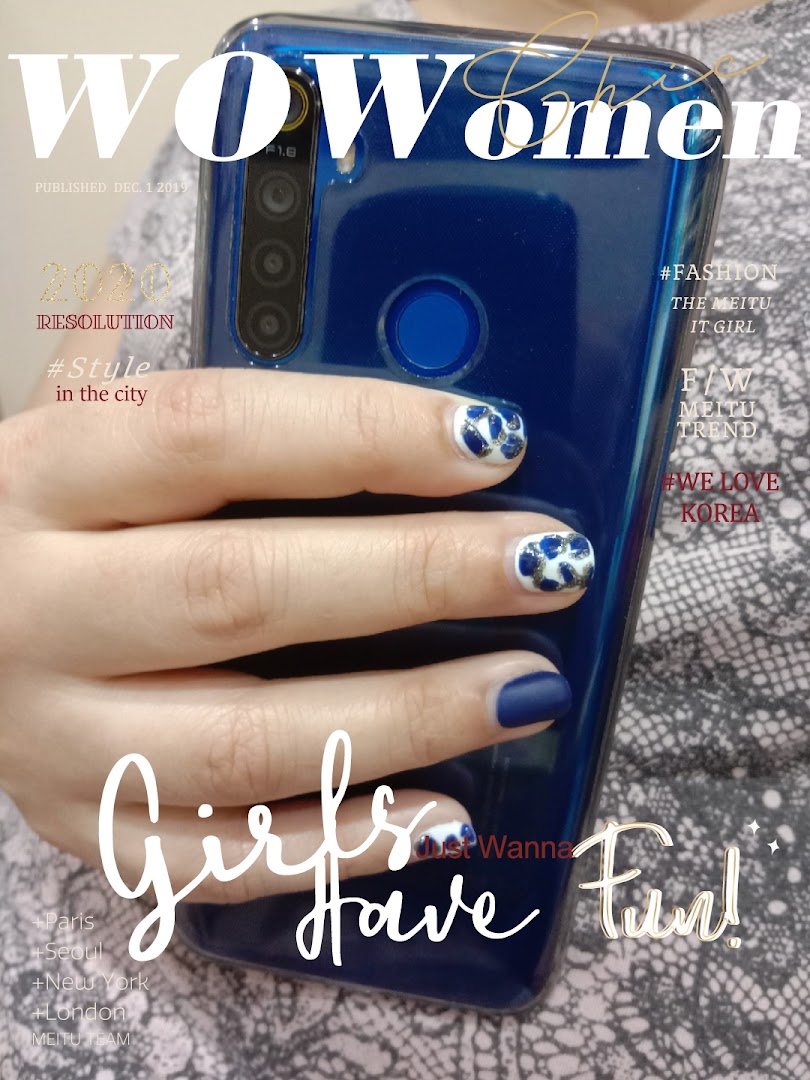 A hand with blue and white patterned nails holds a phone, with magazine-style text overlay.