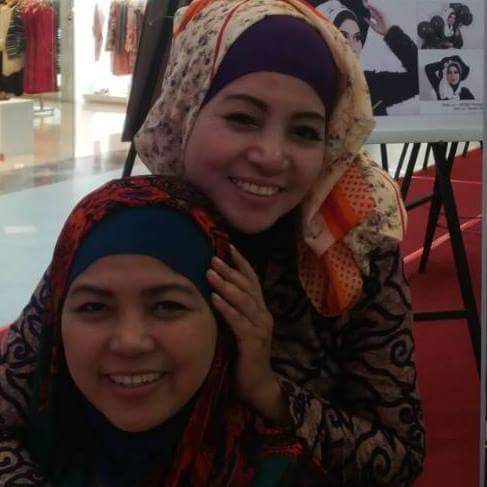 Two smiling women, possibly staff or clients, inside the Niki Beauty Wellness Salon.