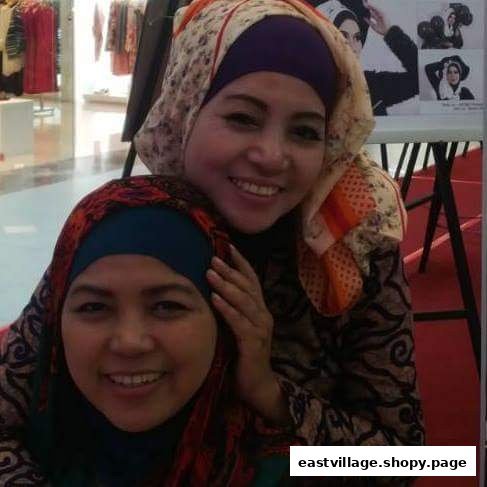 Two smiling women, possibly staff or clients, inside the Niki Beauty Wellness Salon.