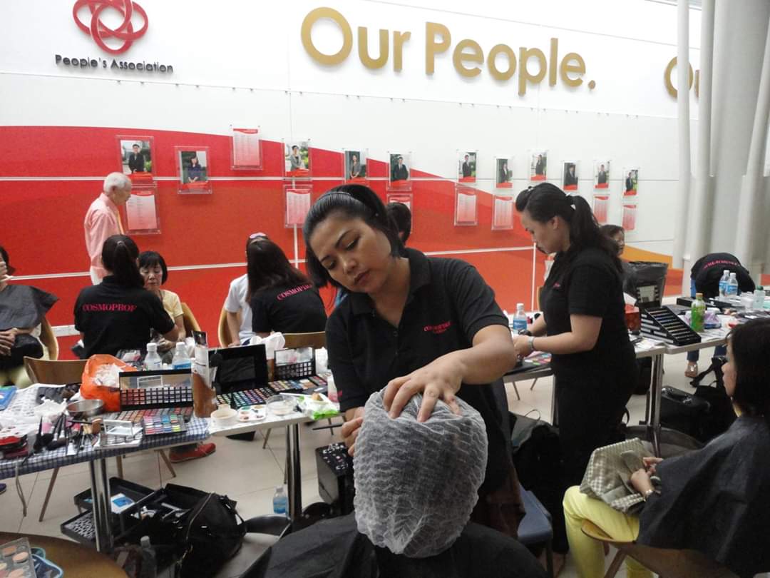Salon staff provide beauty services to clients in an active, well-equipped setting.