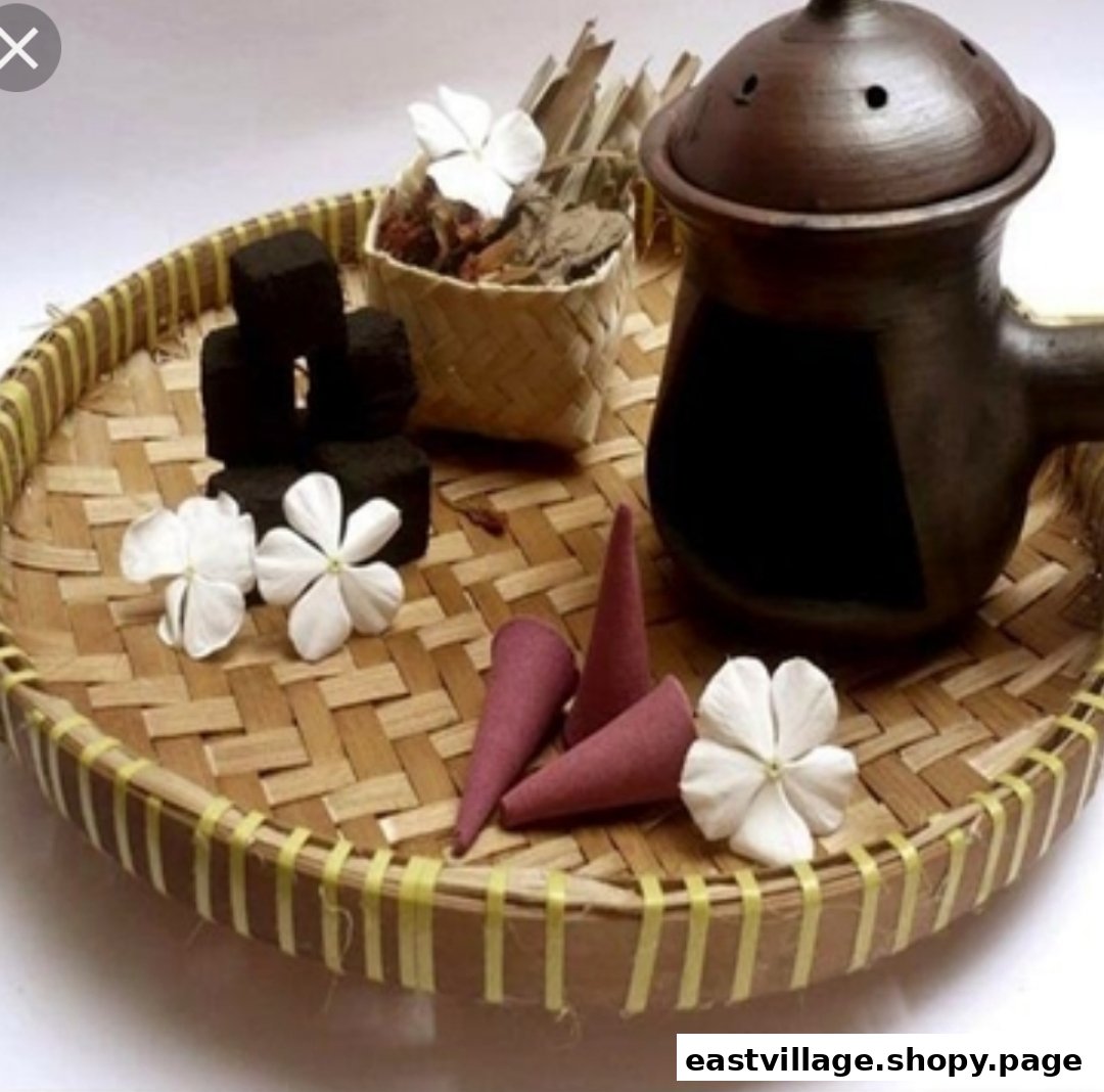 A bamboo tray holds spa essentials: charcoal, incense cones, jasmine flowers, and a ceramic pot.