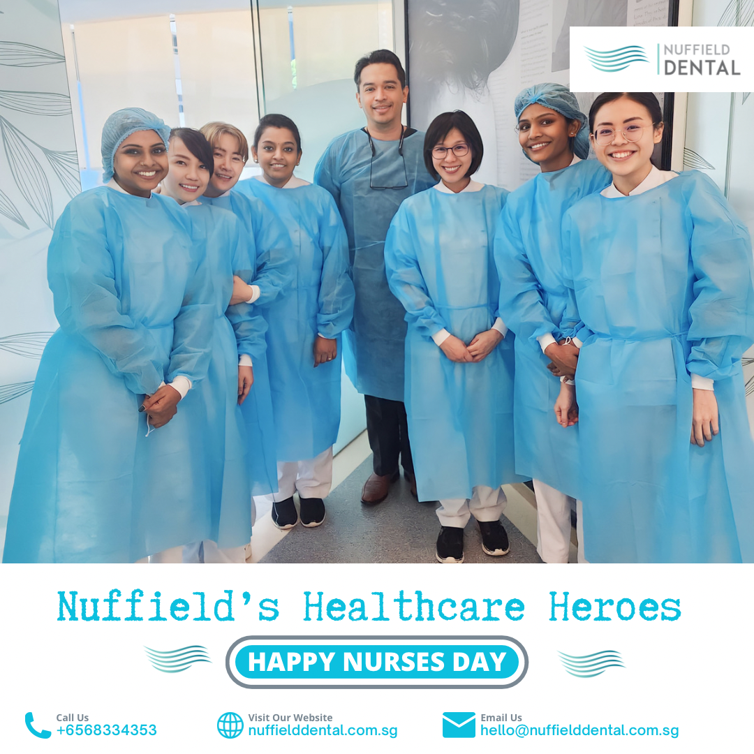 A team of Nuffield Dental staff in blue gowns, celebrating Nurses Day.