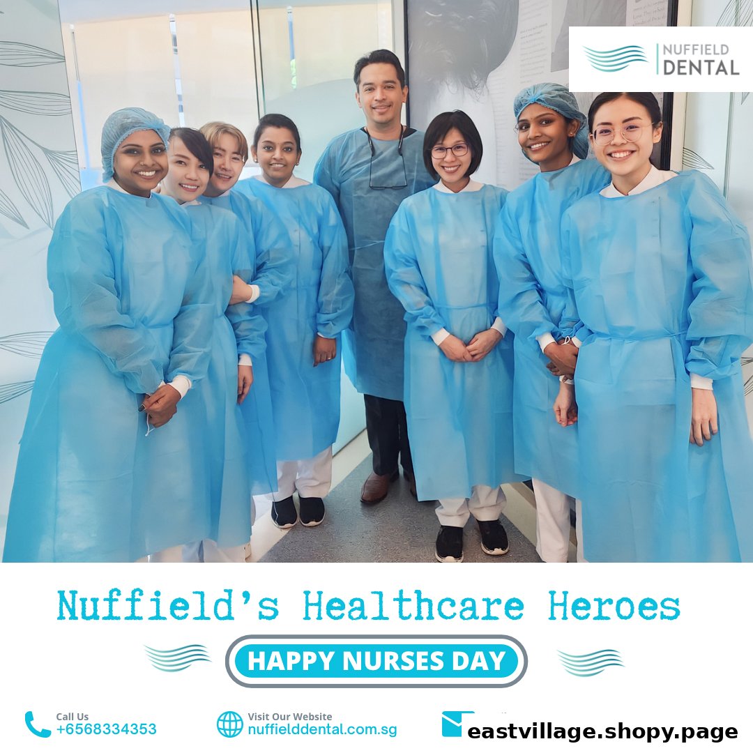 A team of Nuffield Dental staff in blue gowns, celebrating Nurses Day.