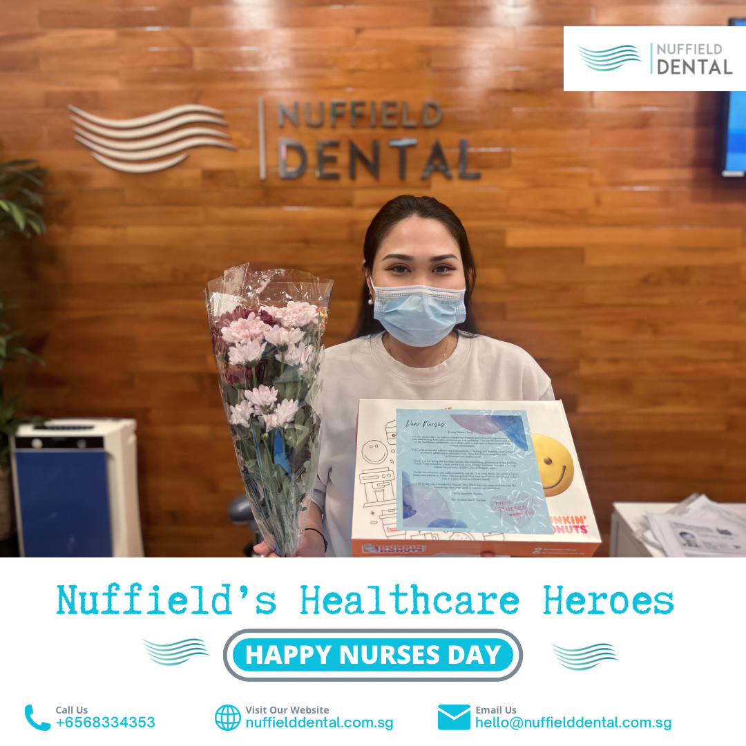 A masked Nuffield Dental staff member holds flowers and a Dunkin' Donuts box, celebrating Nurses Day.