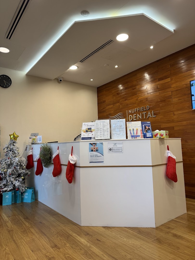 The welcoming reception area of Nuffield Dental, featuring a festive Christmas tree and decorated desk.