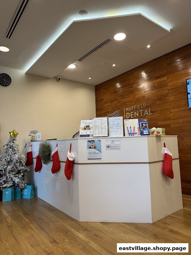 The welcoming reception area of Nuffield Dental, featuring a festive Christmas tree and decorated desk.