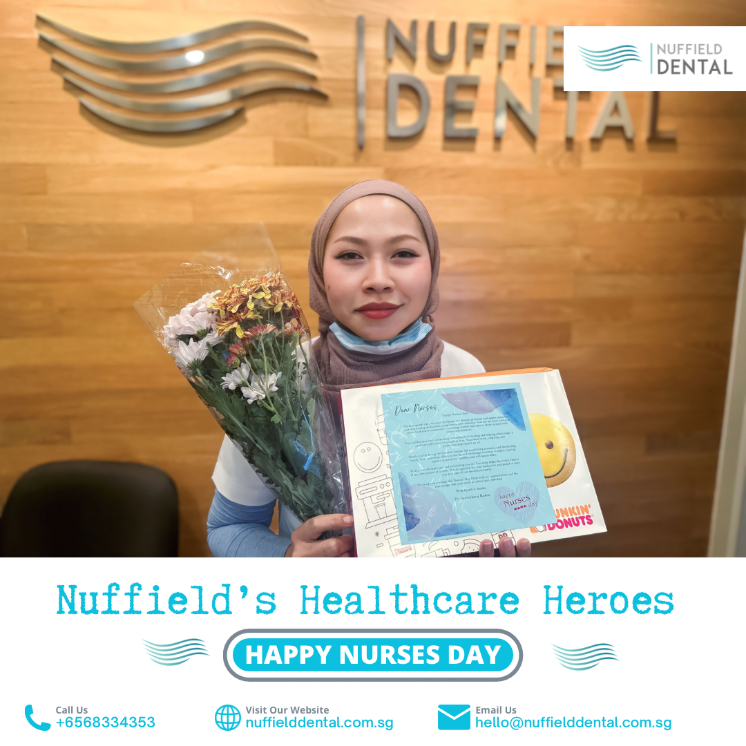 A Nuffield Dental staff member holds flowers and a gift, celebrating Nurses Day.