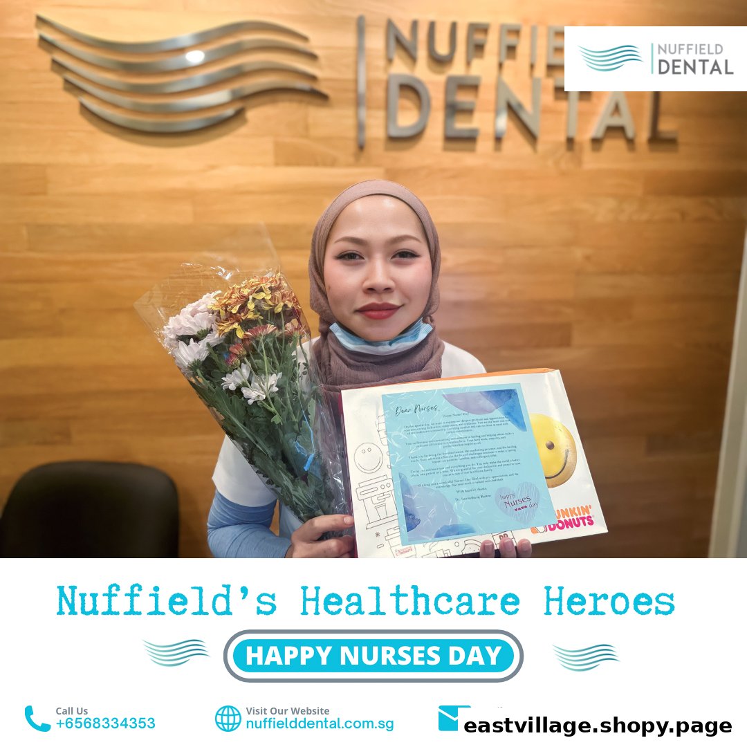 A Nuffield Dental staff member holds flowers and a gift, celebrating Nurses Day.