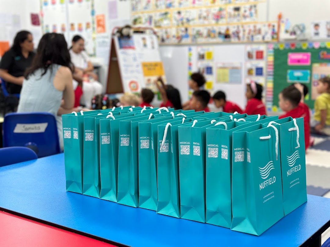 Nuffield Dental gift bags on a table during a community or educational event.