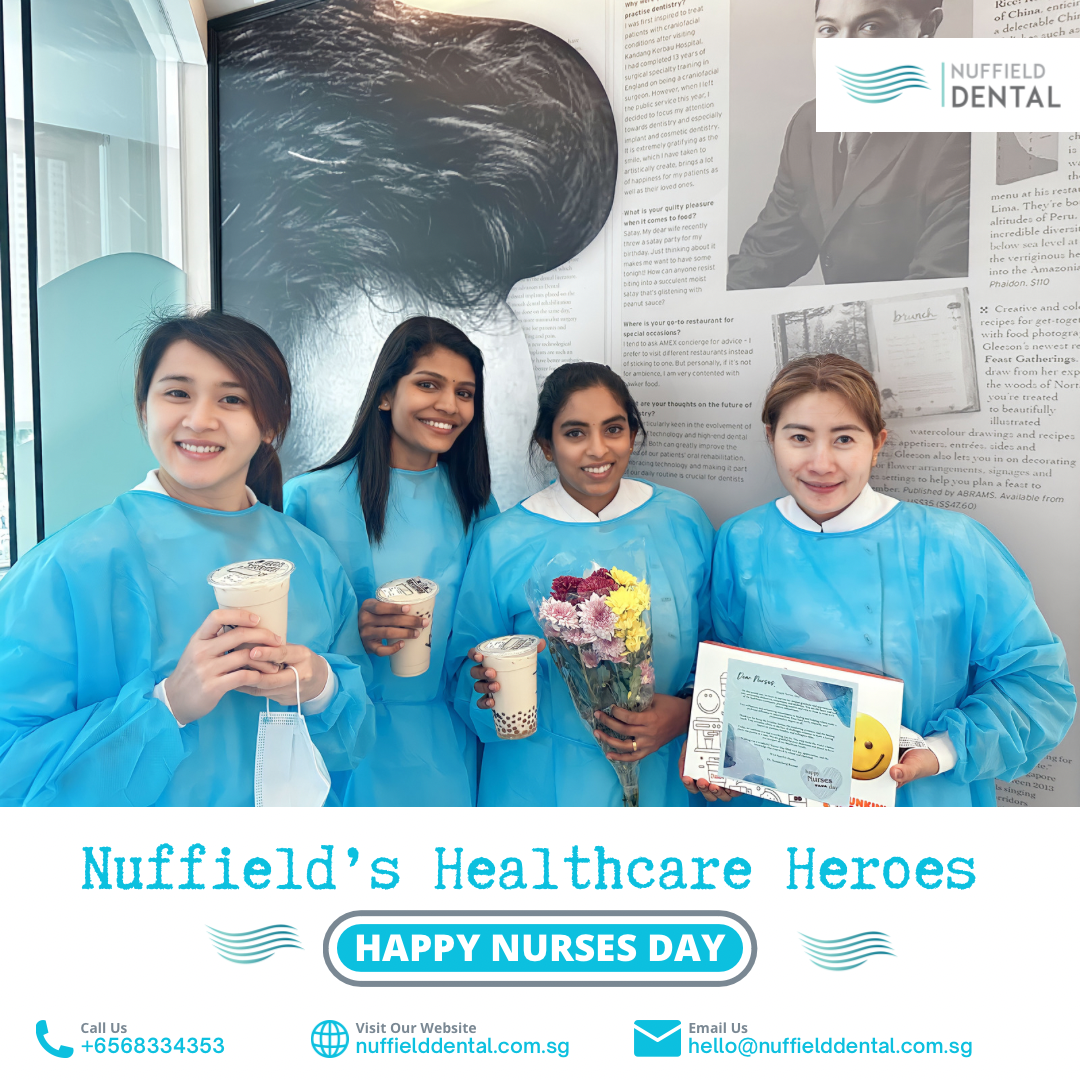 Four Nuffield Dental staff members in scrubs celebrating Nurses Day with drinks, flowers, and a card.