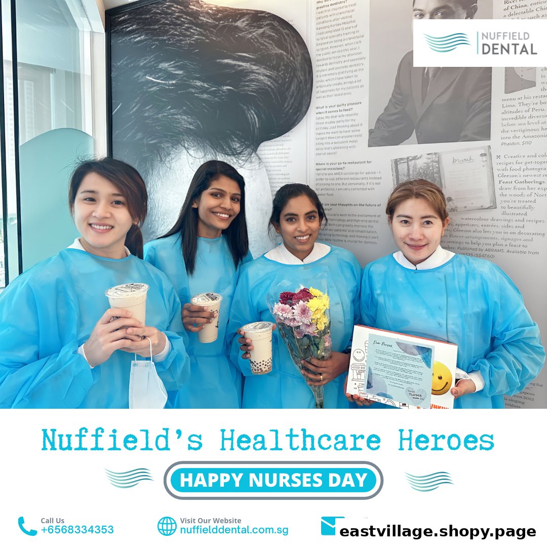 Four Nuffield Dental staff members in scrubs celebrating Nurses Day with drinks, flowers, and a card.