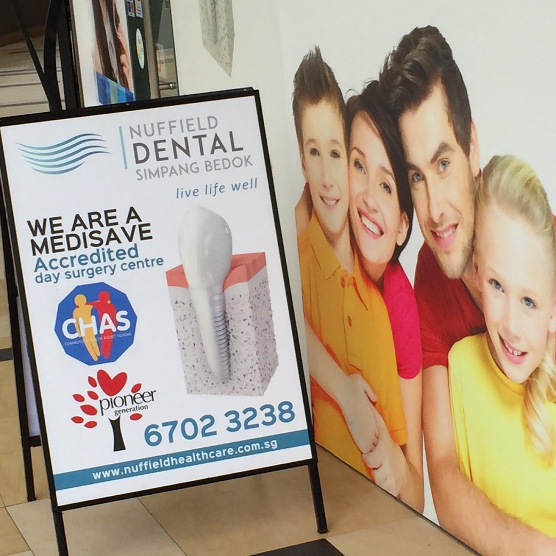 An A-frame sign and wall graphic for Nuffield Dental, highlighting services and contact information.