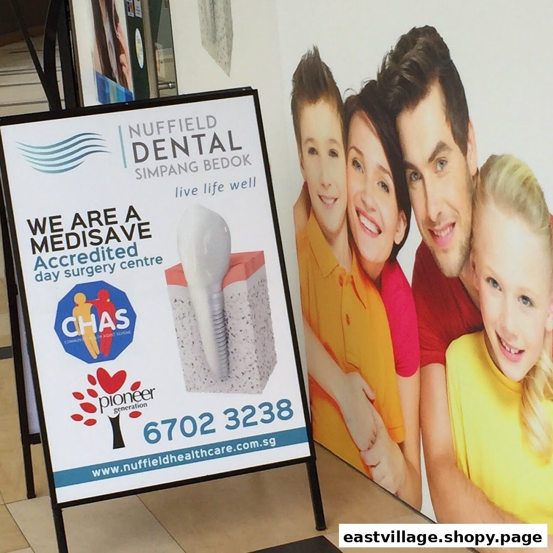 An A-frame sign and wall graphic for Nuffield Dental, highlighting services and contact information.
