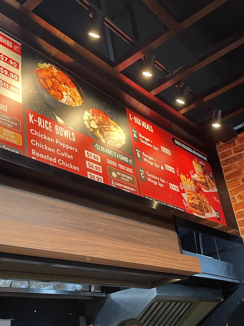 A vibrant menu board displaying Korean fried chicken, rice bowls, and burger combo meals.