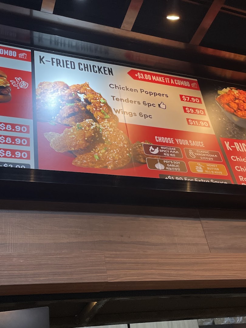 A digital menu board displaying Korean fried chicken options and sauces.