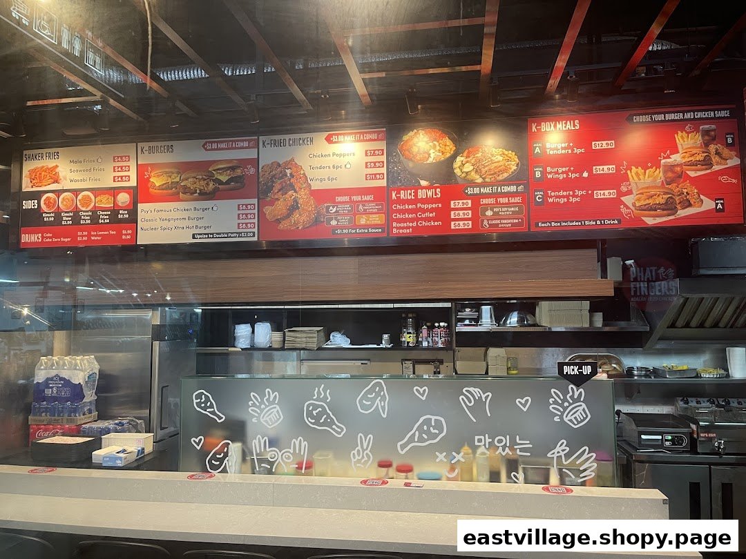 Digital menu board of Phat Fingers Korean Fried Chicken & Burgers, showcasing various food and drink options.