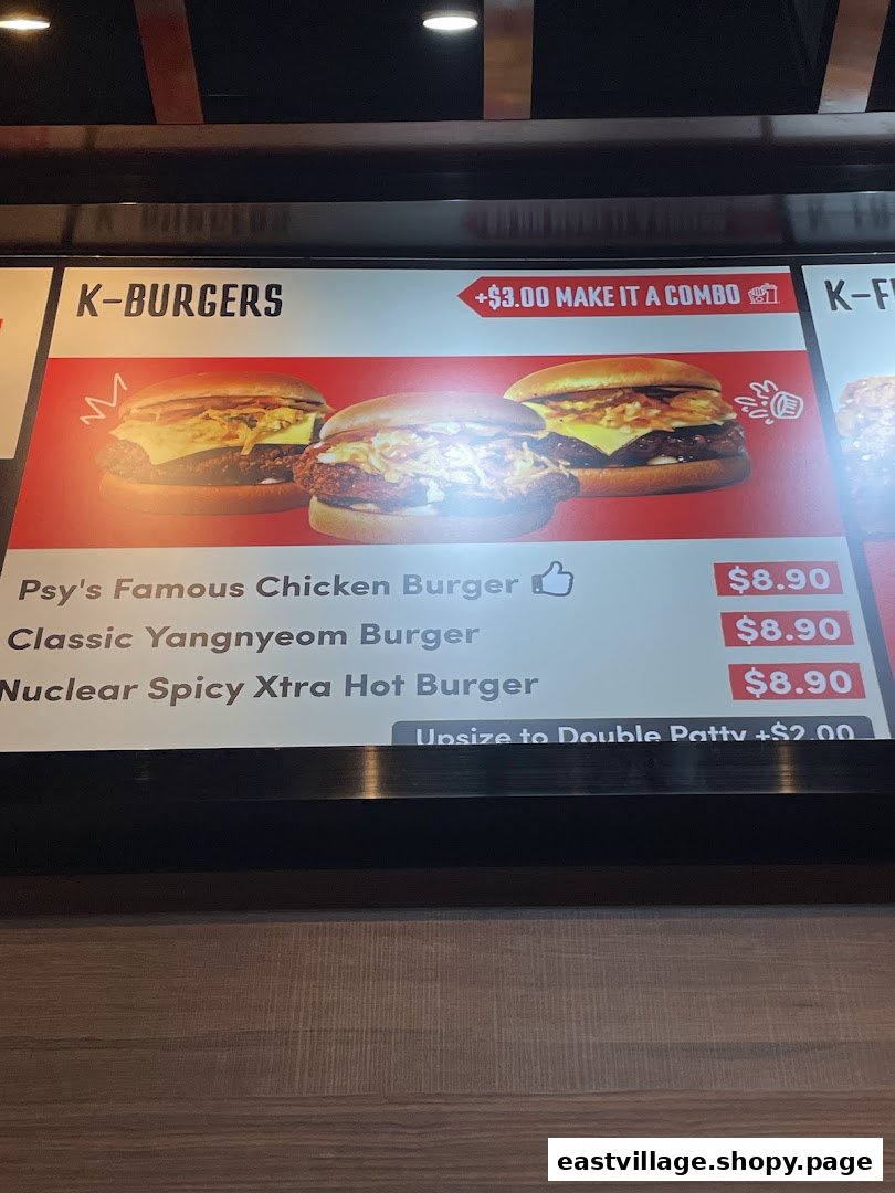 A digital menu board displaying K-Burgers with various options and prices at Phat Fingers.