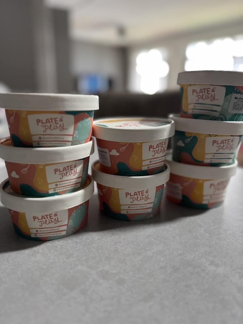 A collection of Plate & Play branded food containers showcasing their product packaging.